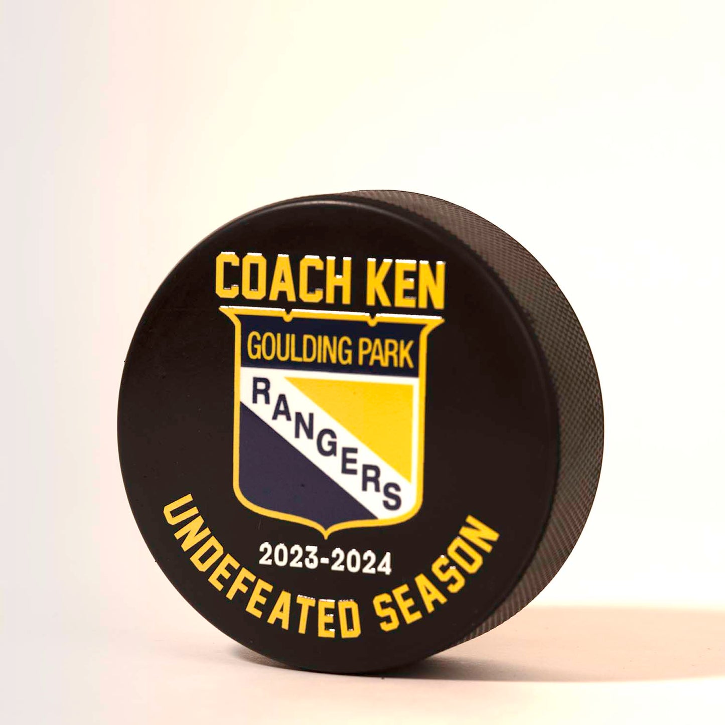 Personalized hockey puck that says undefeated season