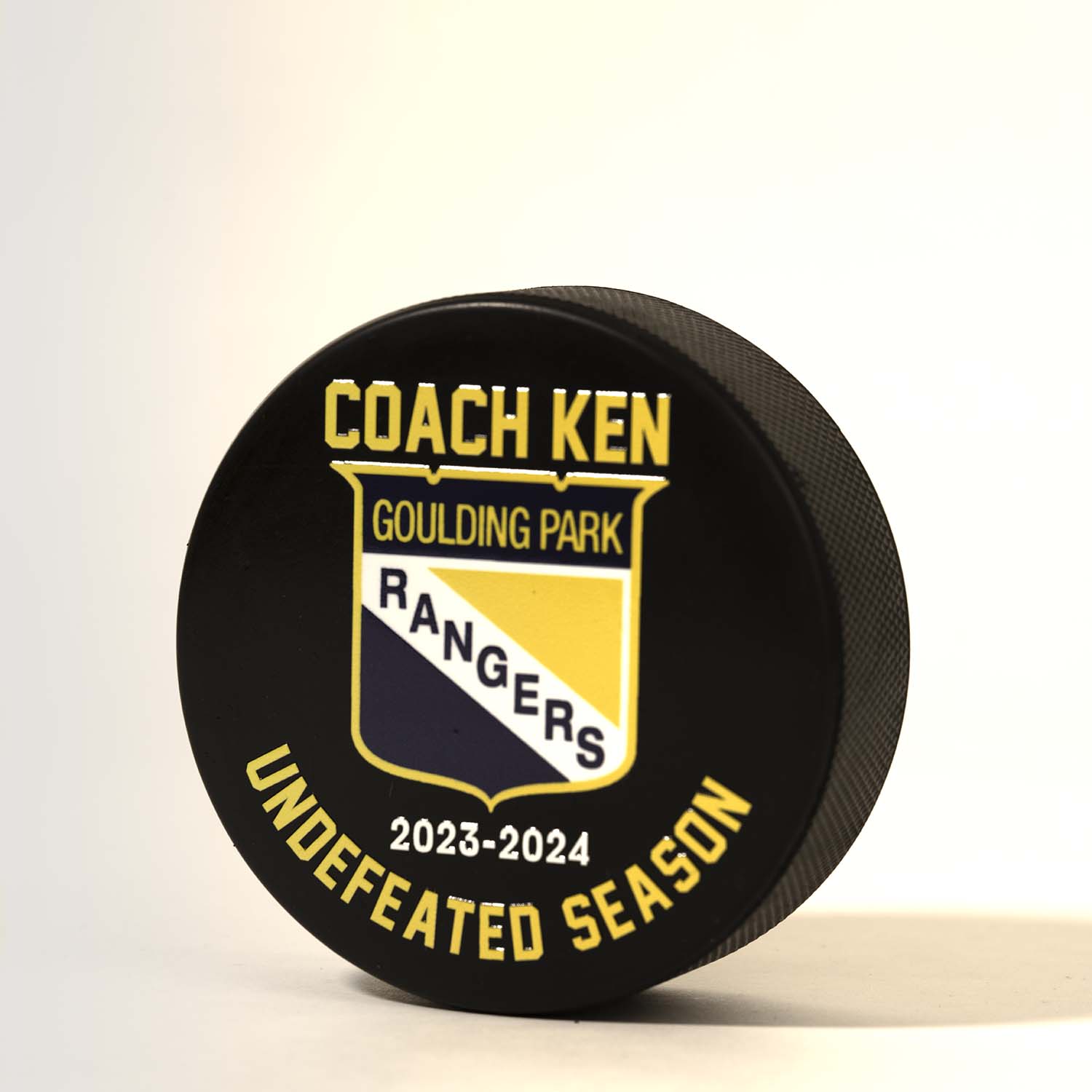 Personalized hockey puck that says undefeated season