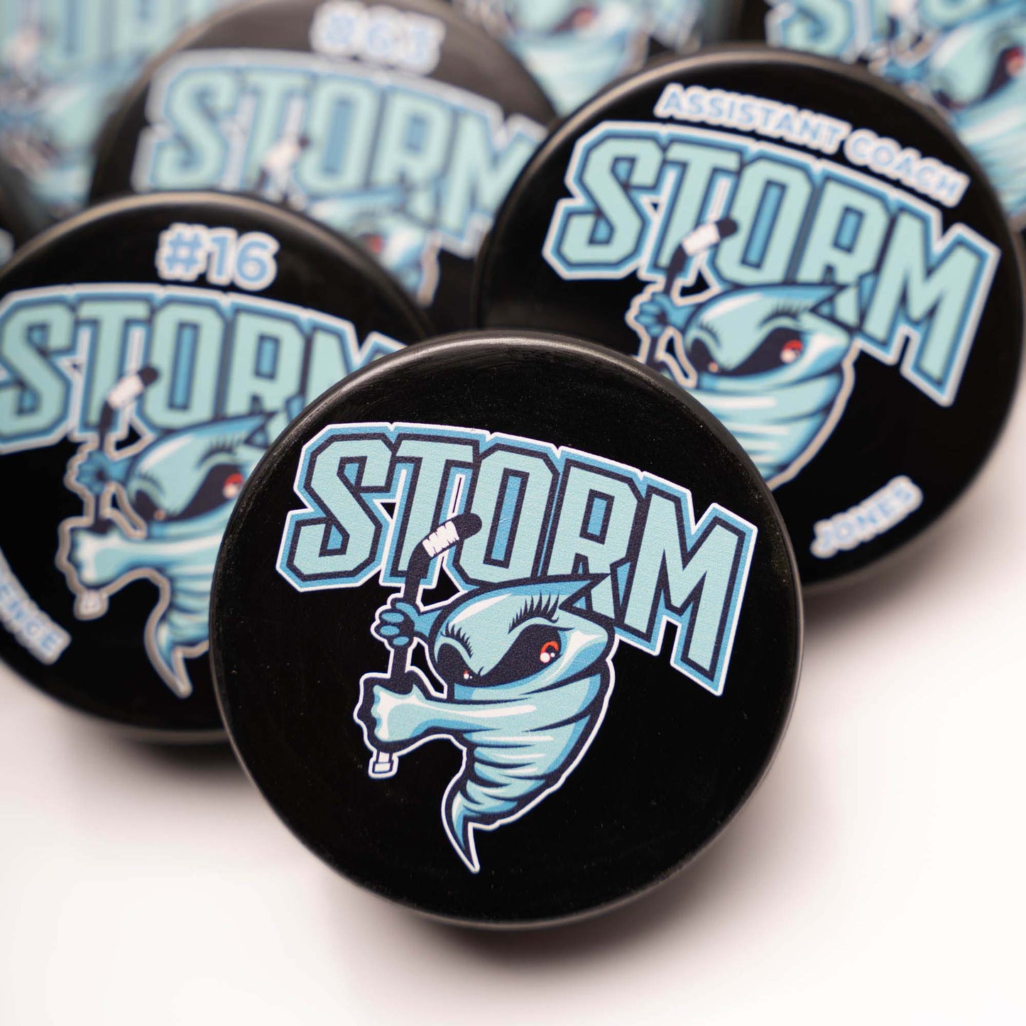 Collection of Storm branded pucks on a white background