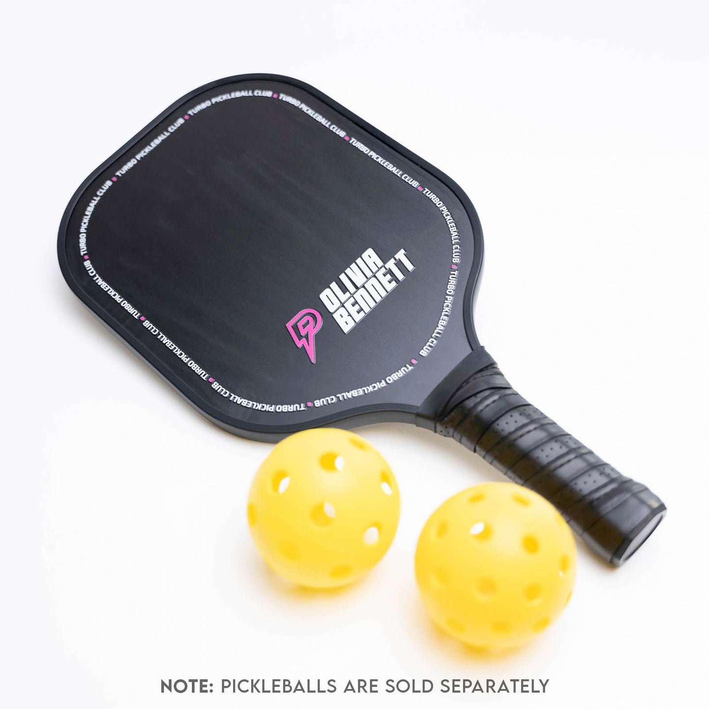 custom pickleball paddle with two yellow pickleballs on a white background