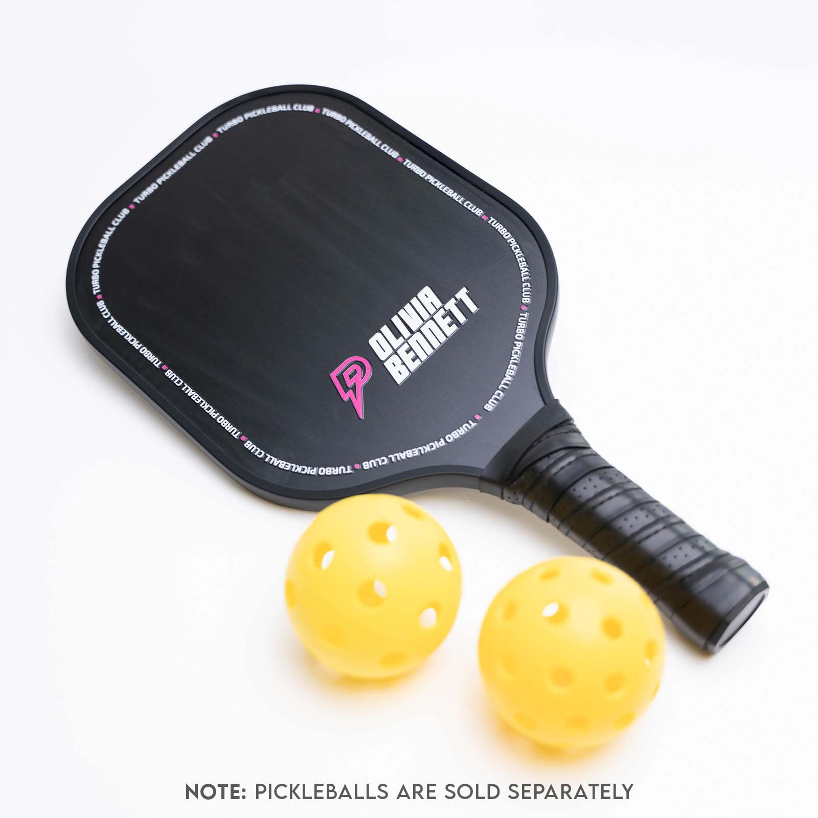 custom pickleball paddle with two yellow pickleballs on a white background