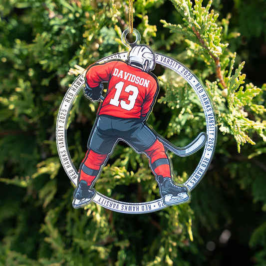 Decorative ornament of a hockey player in red uniform with 'DAVIDSON' and number '13', hanging on a tree.