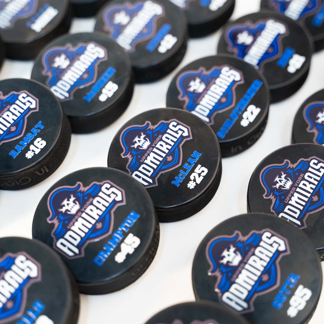 Bulk hockey pucks printed with team logo