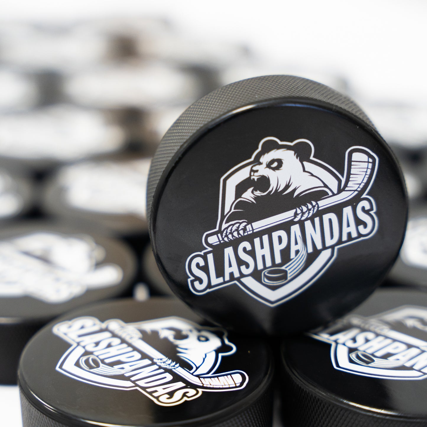 Team logo printed on hockey pucks