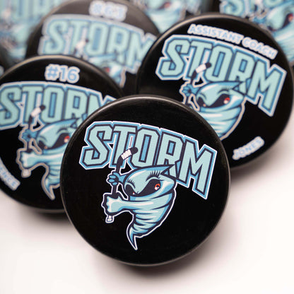 Collection of Storm branded pucks on a white background