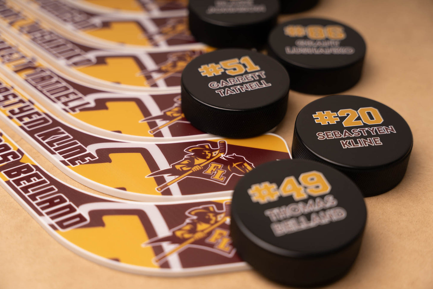 Hockey pucks with player numbers and names 
