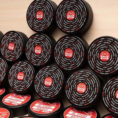Multiple hockey pucks with concentric roster and team logo
