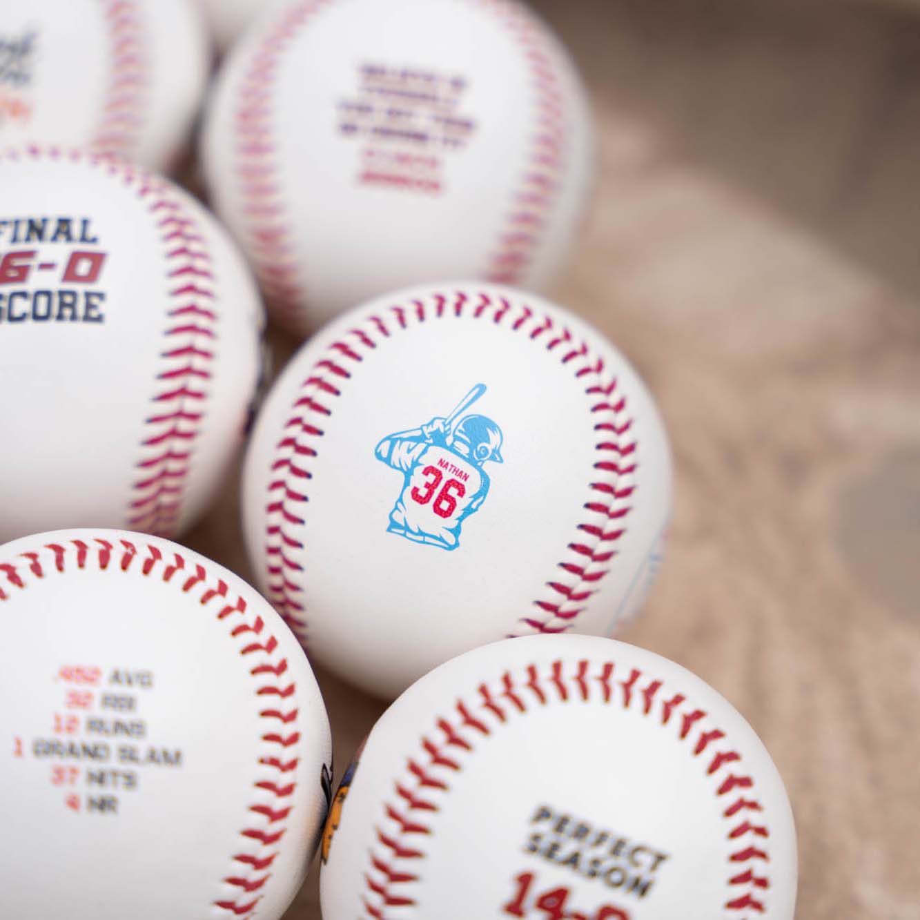 Baseballs with player name and number printed on it