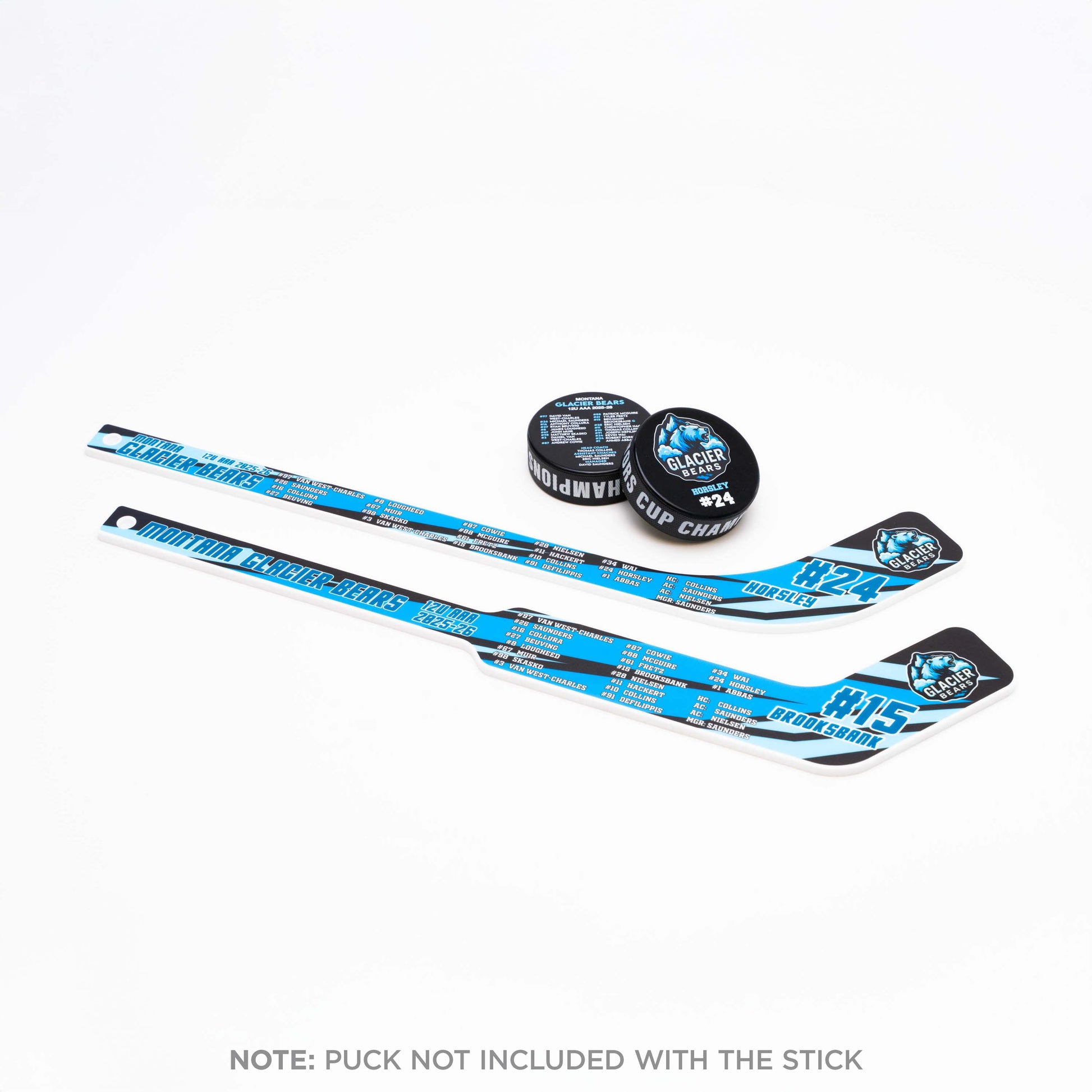 Two hockey sticks and pucks with black and blue designs on a white background