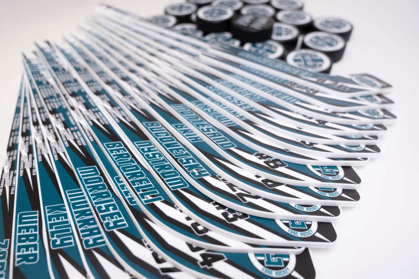 Multiple hockey sticks with visible branding on a white background