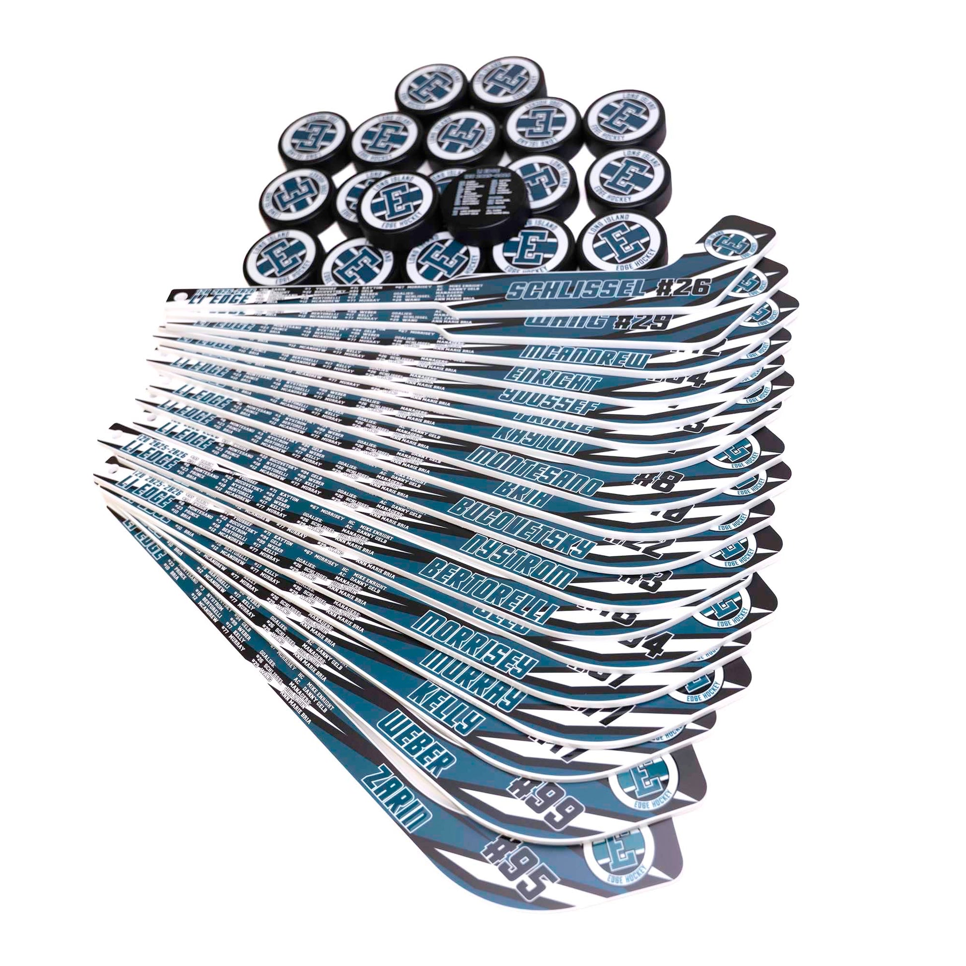 Stack of hockey sticks and pucks with visible branding on a white background