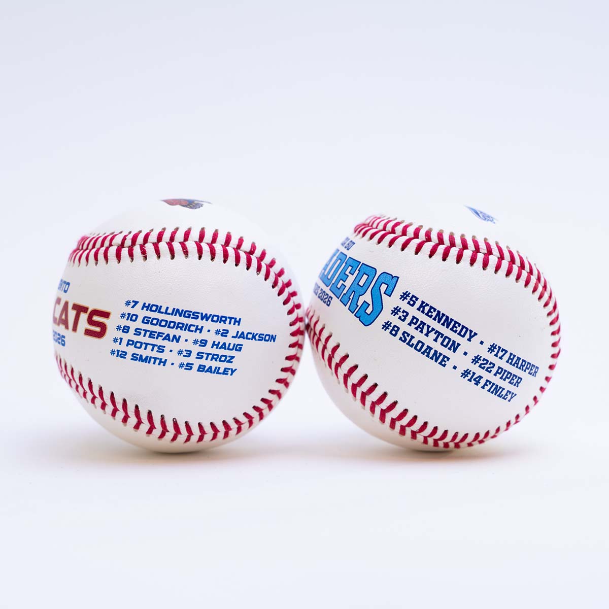 Two baseballs with player names and numbers printed on a white background
