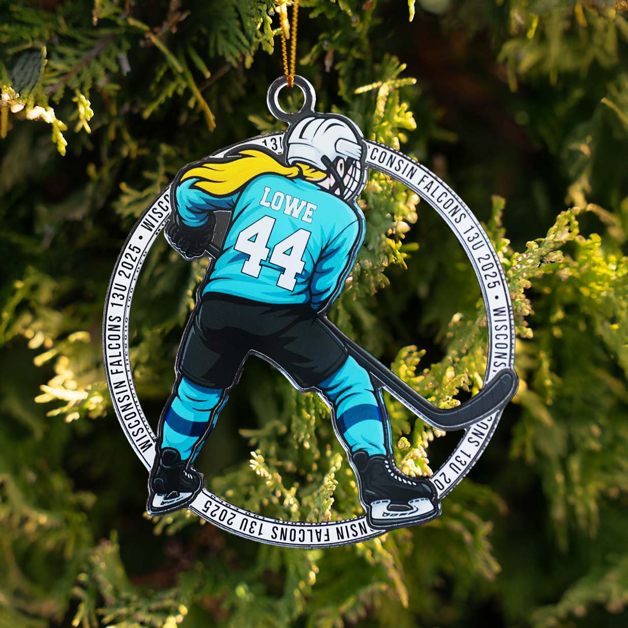 Female Hockey player ornament with 'Lowe 44' on a green tree background