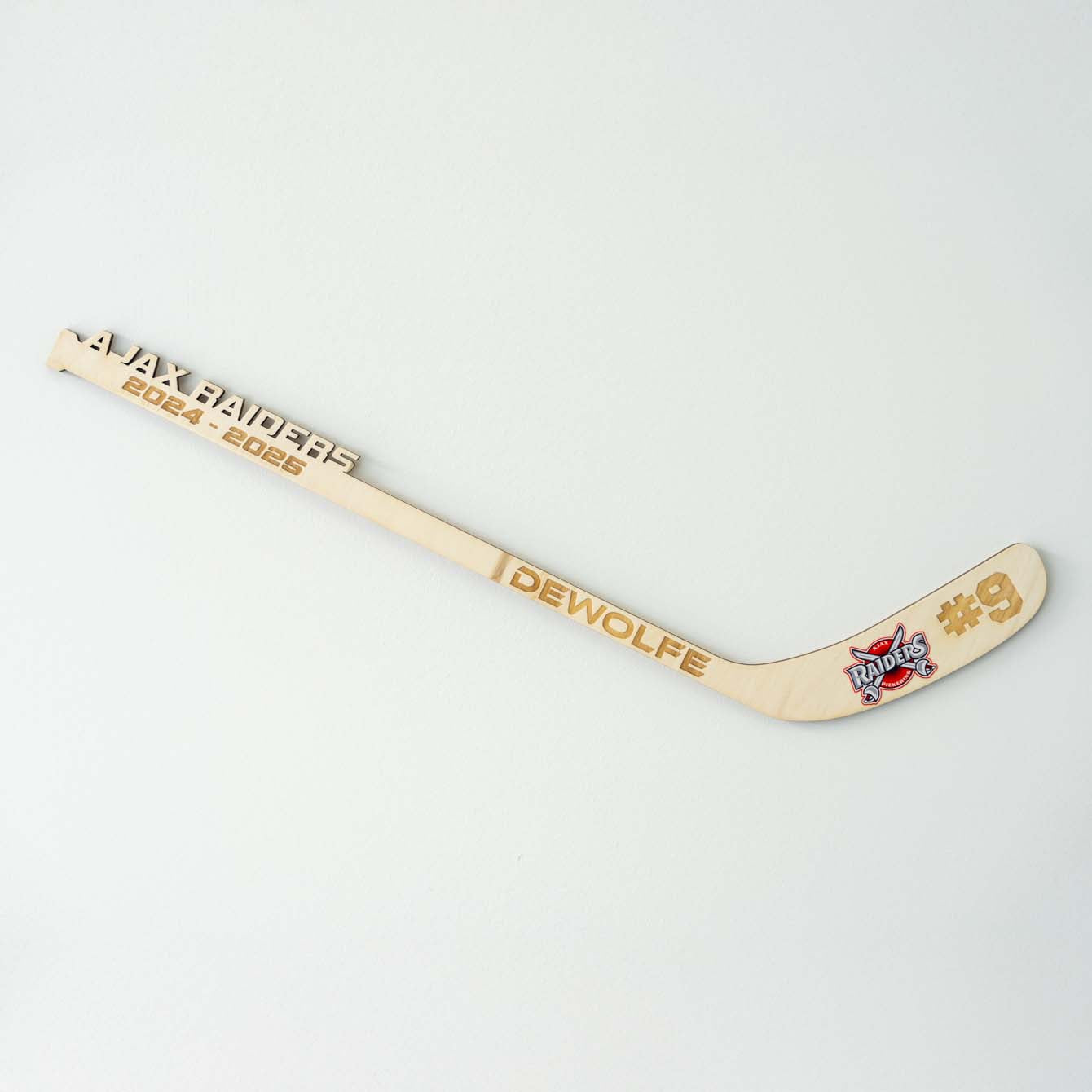 player name, number engraved on player stick with full color logo