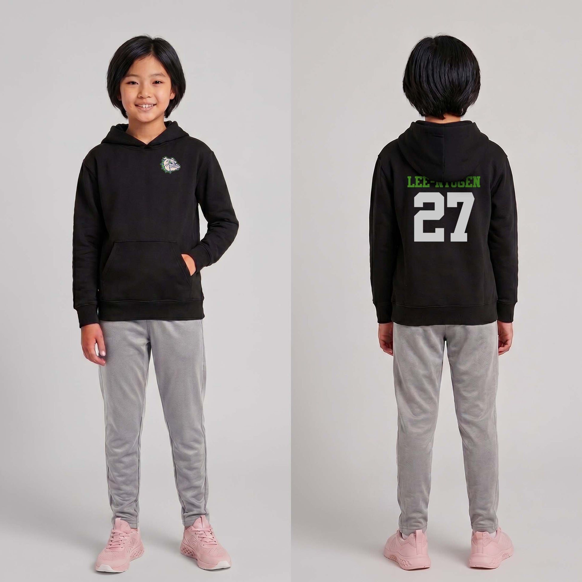 Child wearing a black hoodie with text and numbers, standing against a plain background