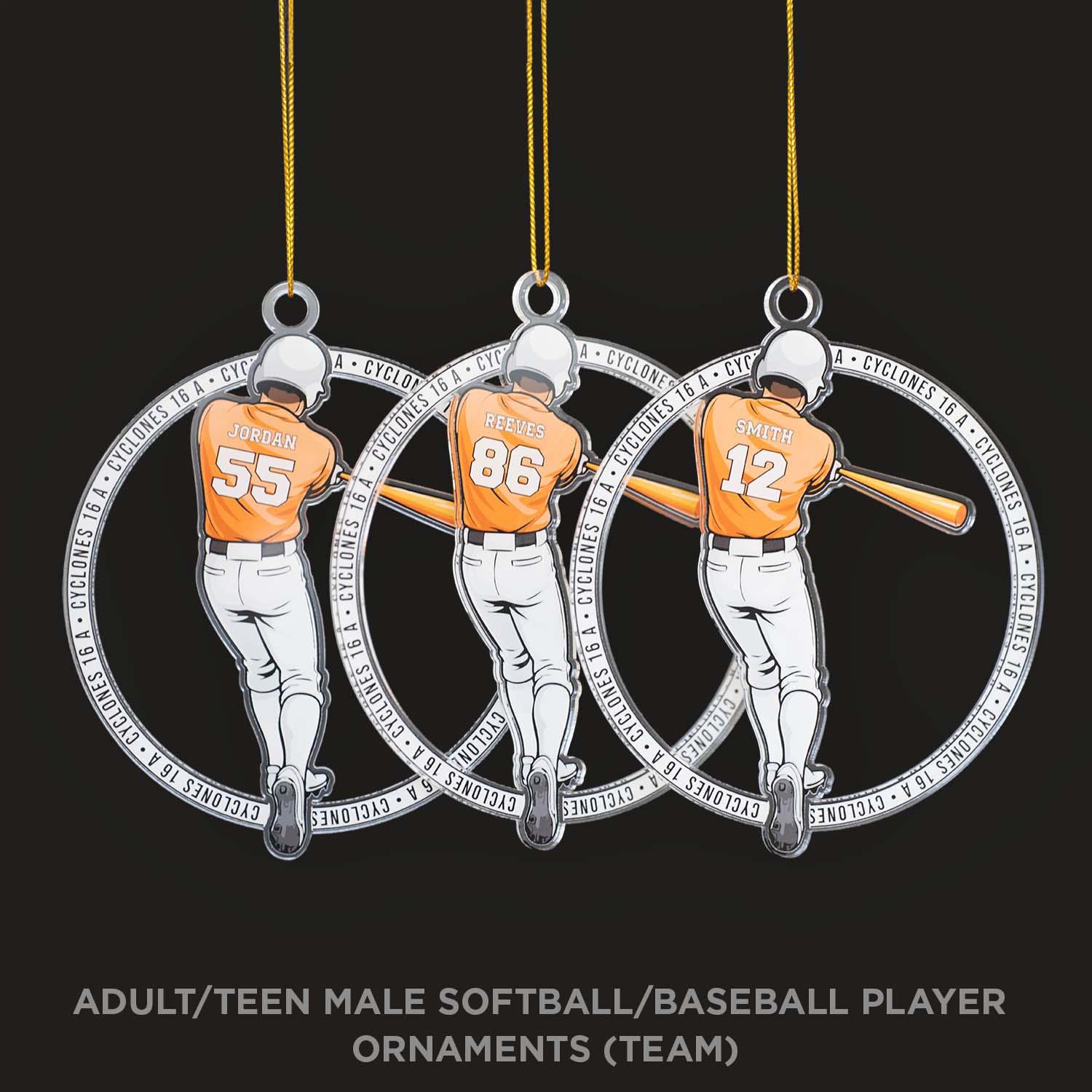 Three baseball player ornaments hanging from strings against a black background.