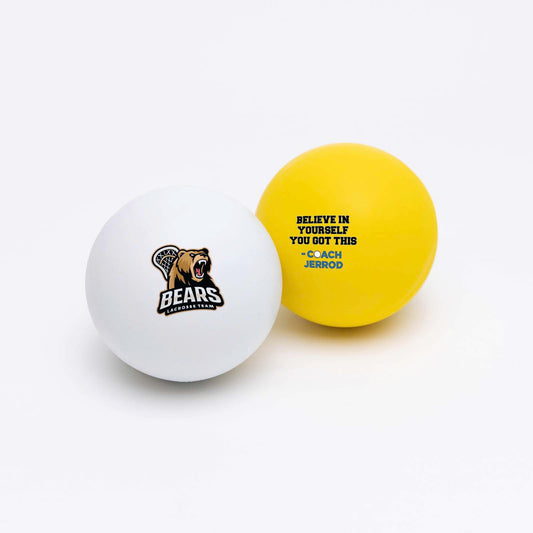 Two lacrosse balls, one white and one yellow, with a bear logo and coach message on a white background.